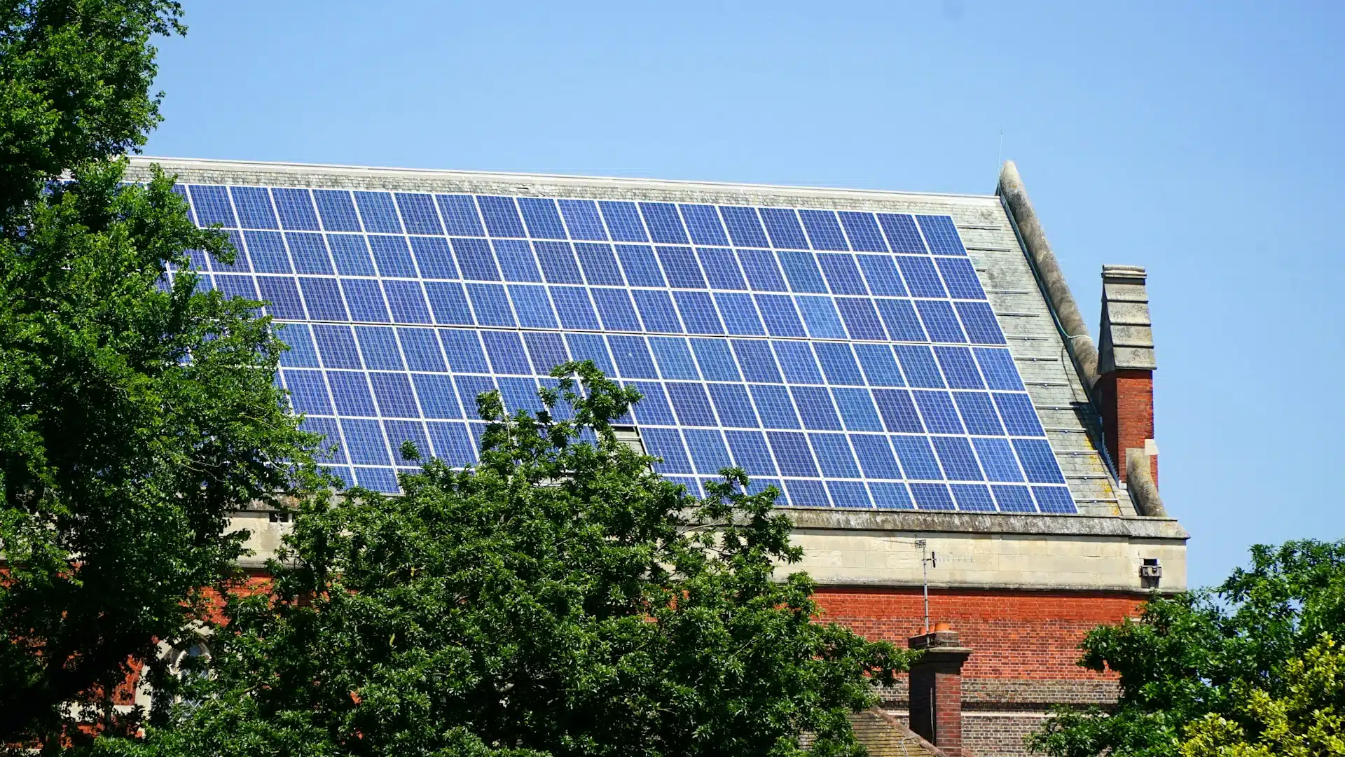 Side view of extensive solar panel installation on UK home